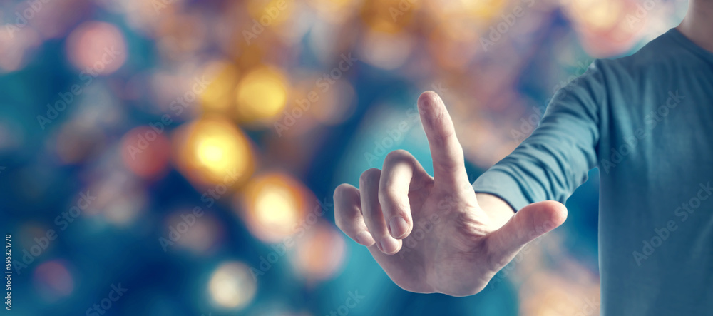 Young man pointing on blurred blue city light background