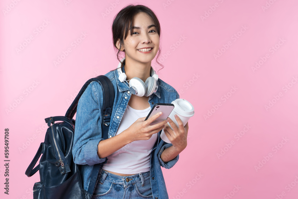 Portrait of young Asian woman student standing with smartphone coffee and backpack.College Teenager 