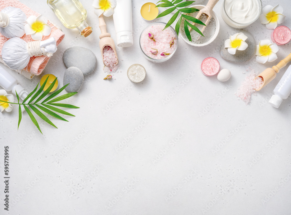 Beauty and spa concept on white concrete background. Blue clay with cream and massage stones. Massag