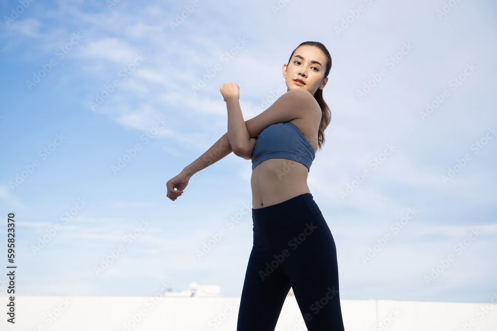 Young beauty Asian woman stretching workout outdoor rooftop. She warming up