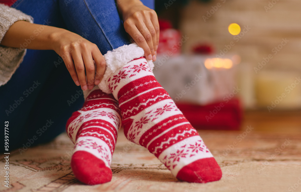 You know its Christmas when the cosy socks come out. a unrecognisable woman trying on socks during C