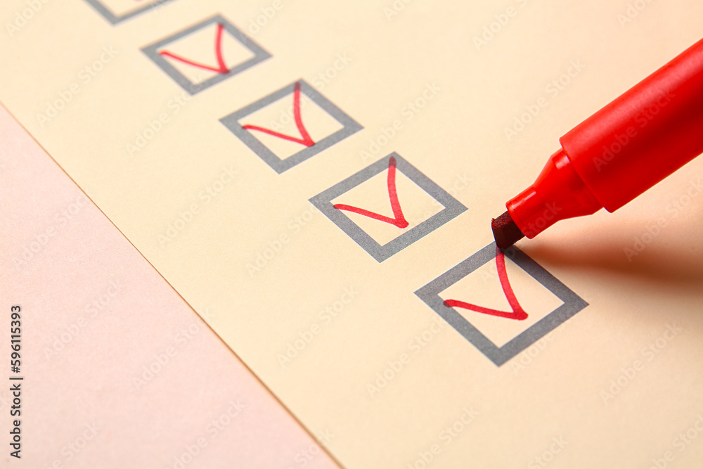 Red pen marking on checklist box, closeup