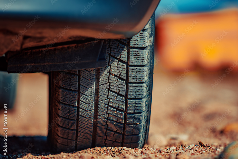 Car wheel on sand close-up view