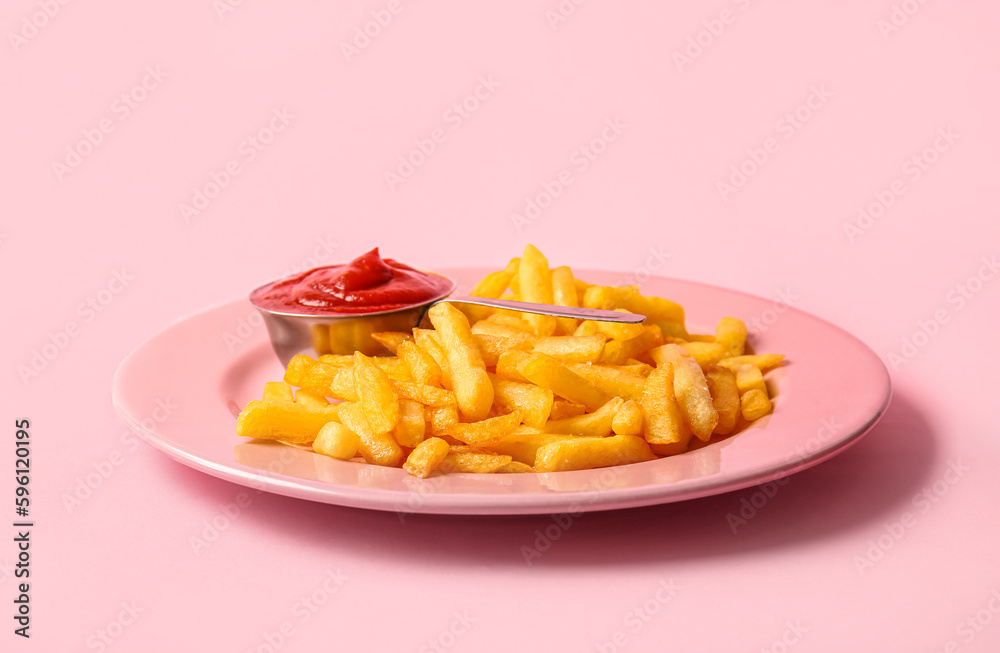 Plate of tasty french fries and ketchup on pink background