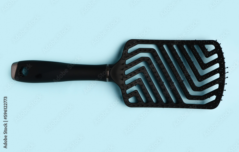 Hair brush on blue background