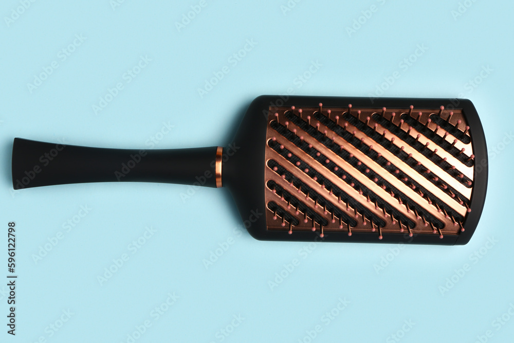 Hair brush on blue background