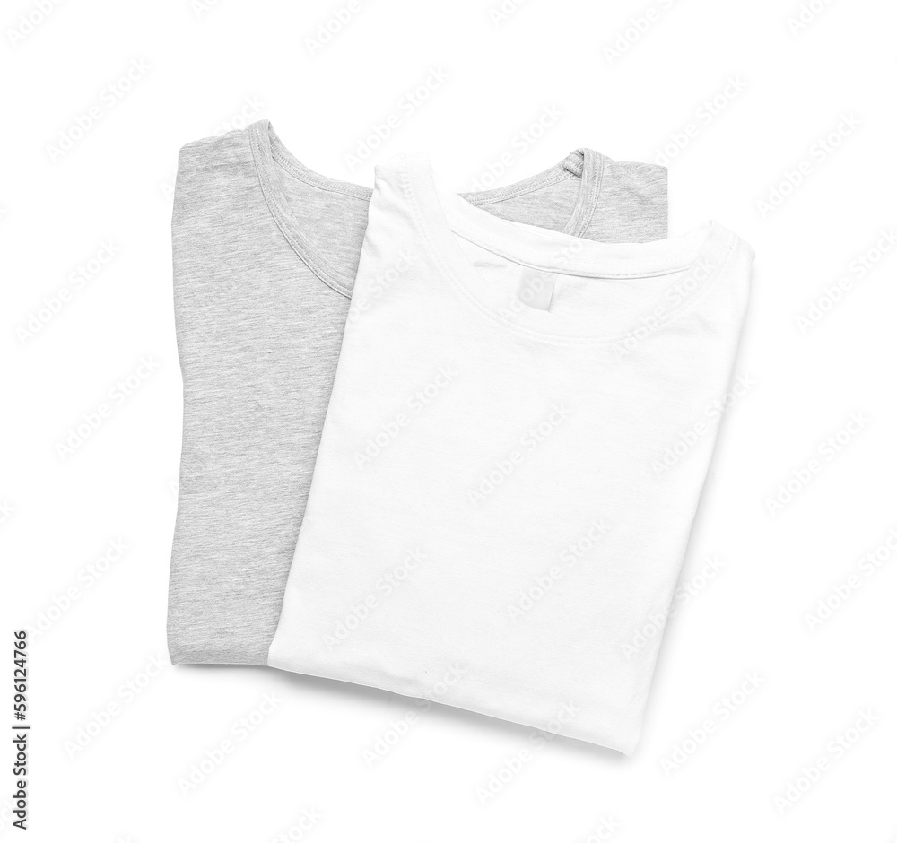 Folded stylish t-shirts on white background