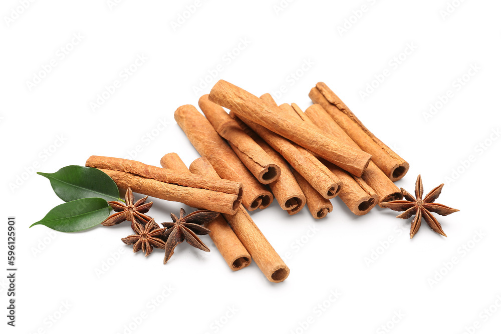 Cinnamon sticks with leaves and anise on white background