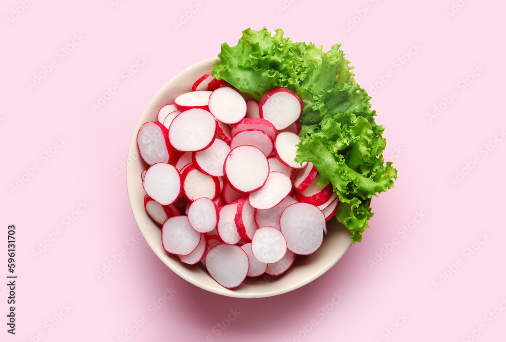 Bowl with sliced radish and lettuce on pink background