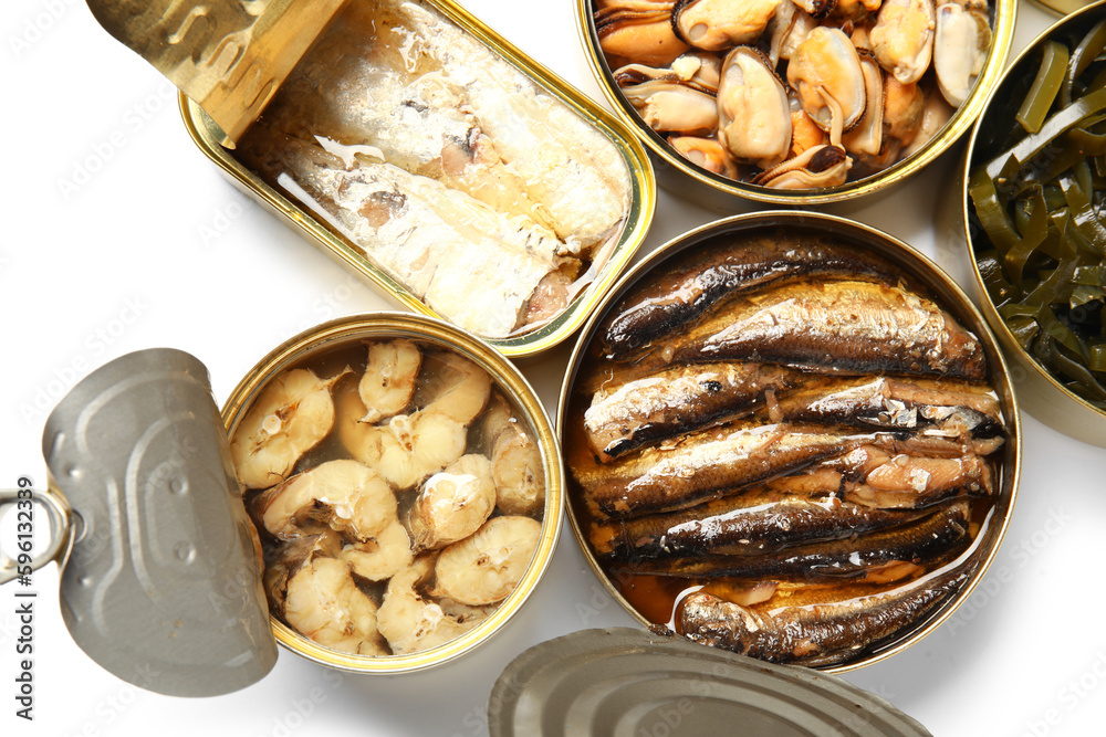 Opened tin cans with different seafood isolated on white background