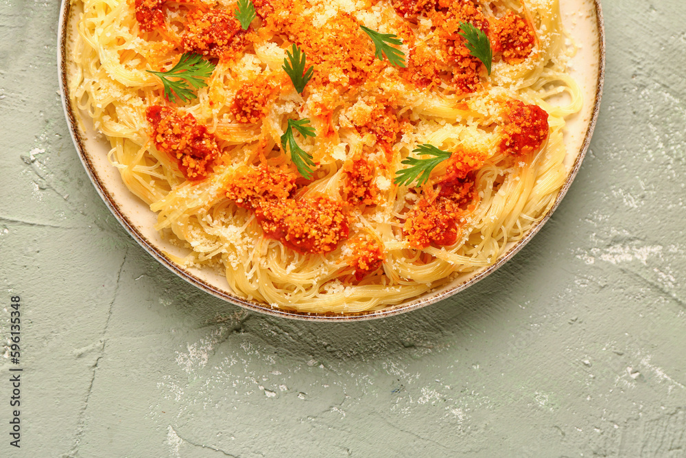 Plate of tasty Italian pasta with Parmesan cheese on light background