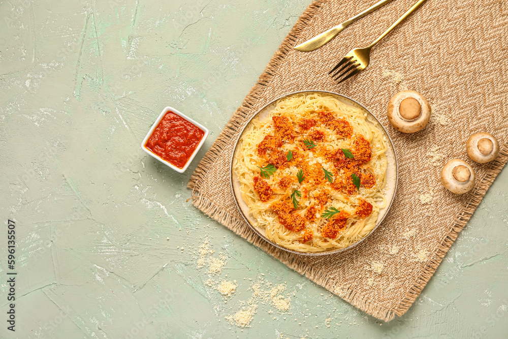 Plate of tasty Italian pasta with Parmesan cheese and sauce on light background