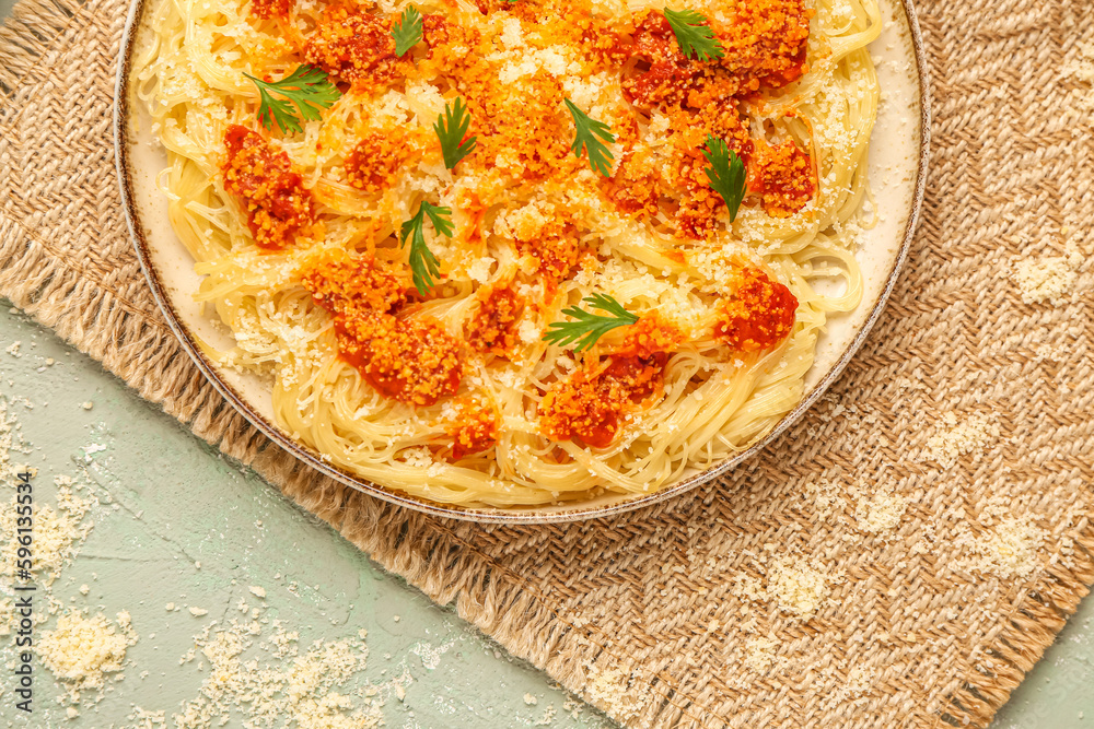 Plate of tasty Italian pasta with Parmesan cheese on table, closeup