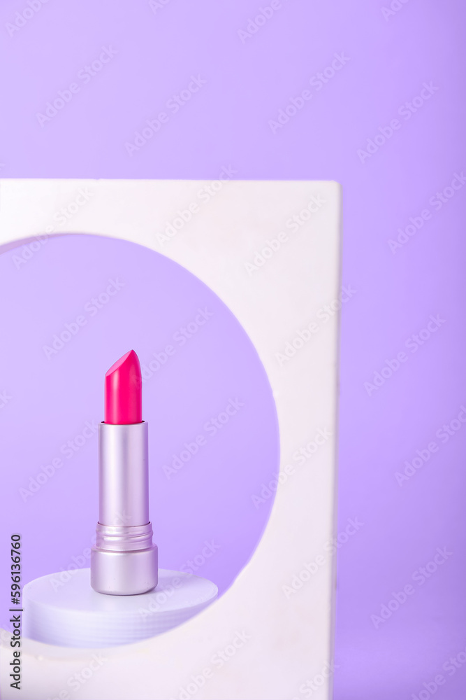 Decorative plaster podiums and lipstick on lilac background