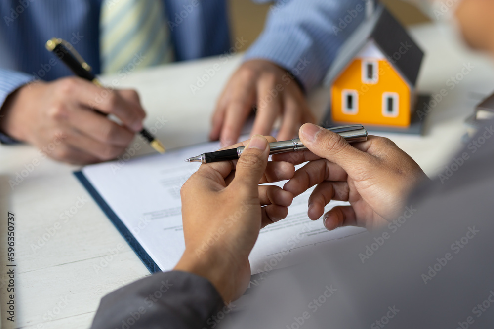 Real estate agent discuss about the terms of the home purchase agreement and asked the customer to s