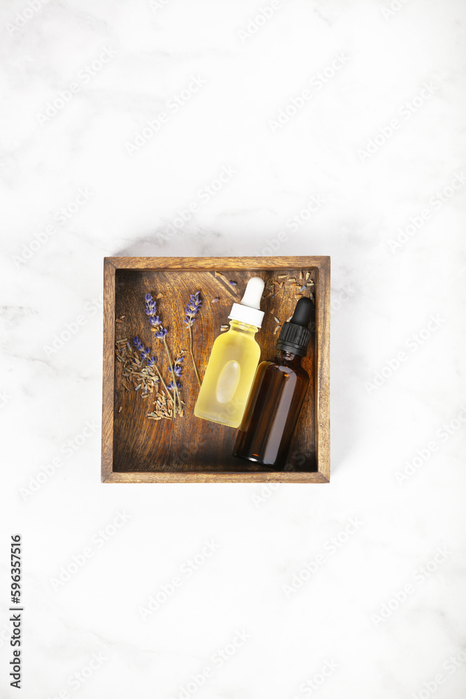 Flat lay composition with lavender flowers and natural cosmetic on white marble background