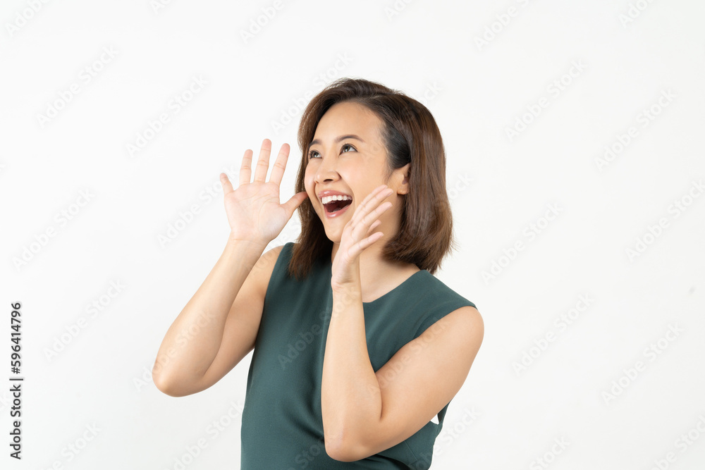 Young Asian woman doing a shocked surprise gesture shouting with hands cupped around mouth isolated 