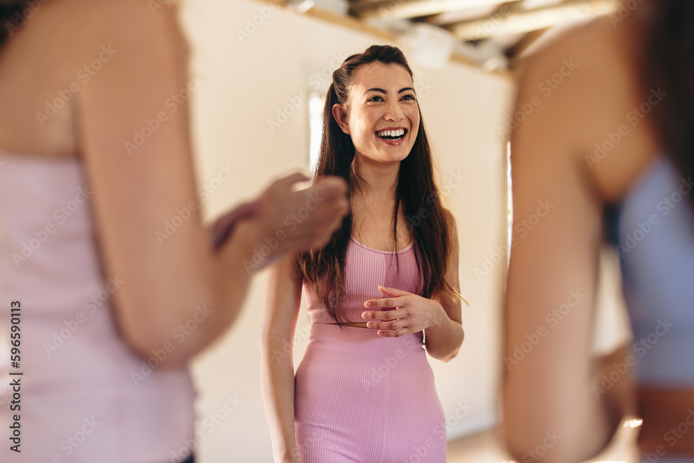 Woman standing in a circle with her yoga class