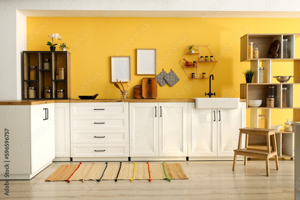 Interior of modern kitchen with white counters