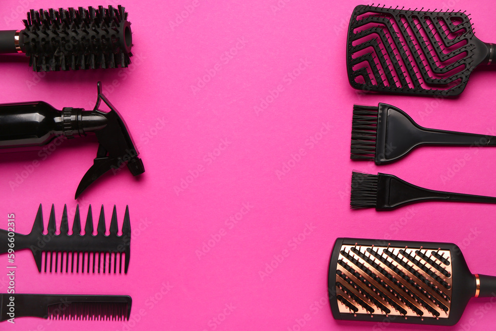 Frame made of hairdressers brushes with spray on pink background