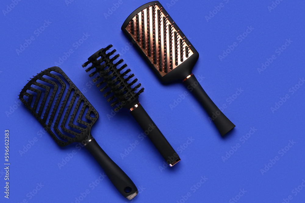 Hair brushes on blue background