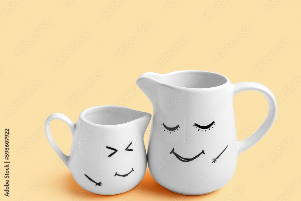 Pitchers with happy faces for Friendship Day on beige background