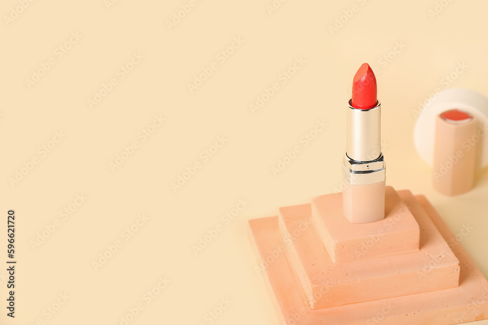 Decorative plaster podium and lipstick on yellow background