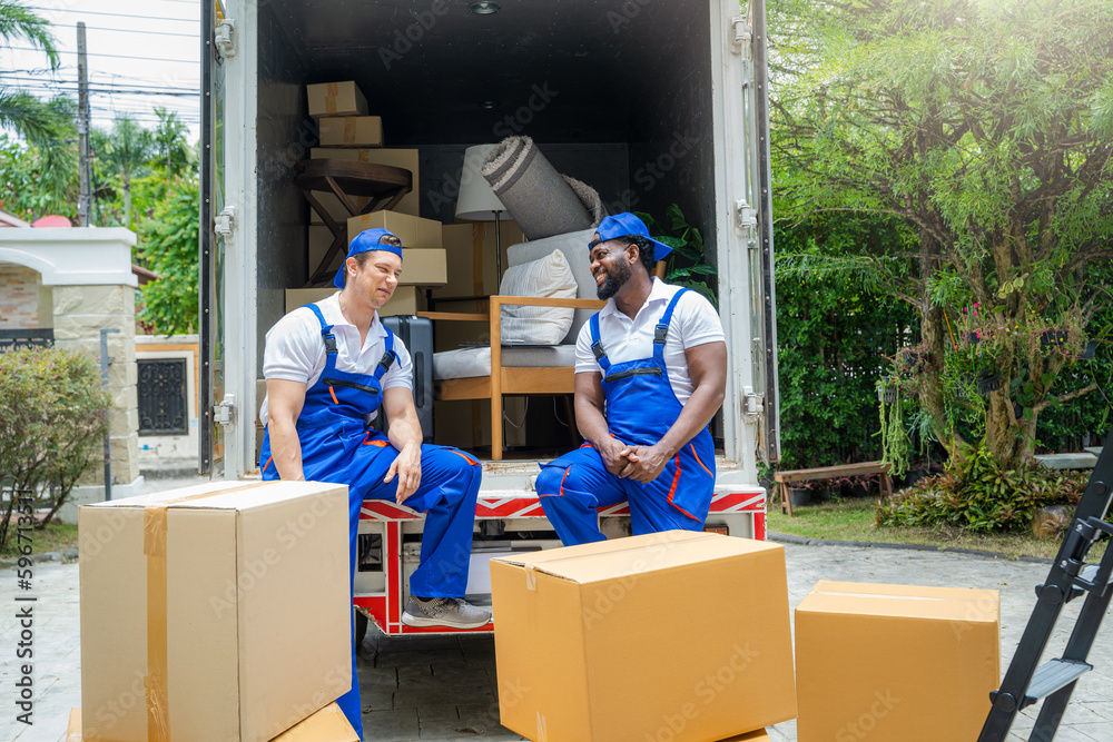 Moving service workers unloading boxes and checking list,After unloading boxes from truck before sen