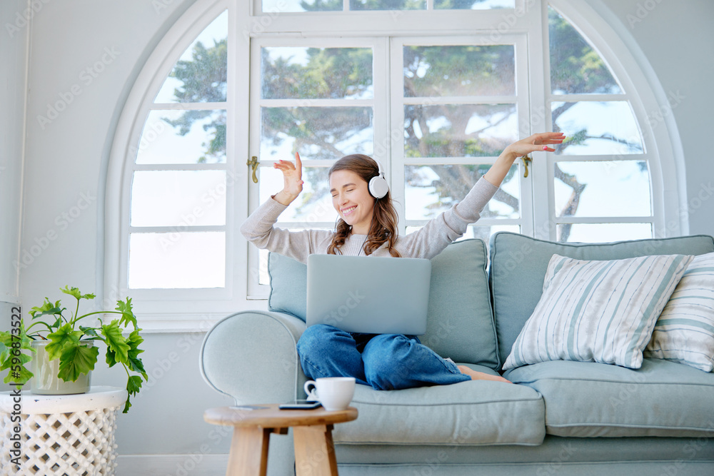 Get lost in your favourite song. Full length shot of an attractive young woman listening to music wh