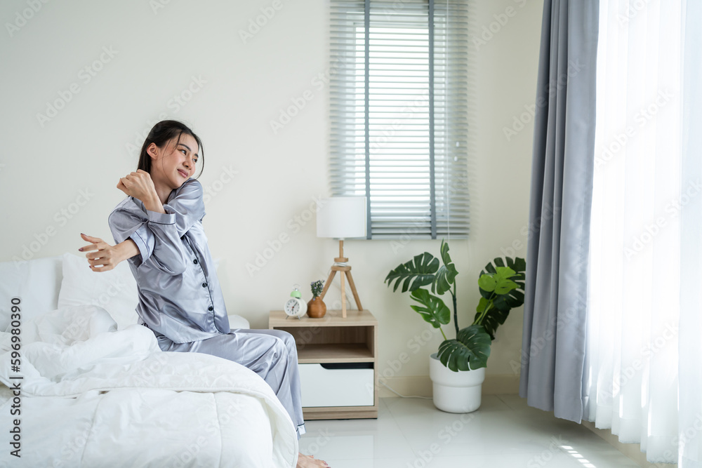 Asian beautiful girl in pajamas wake up in the morning with happiness. 