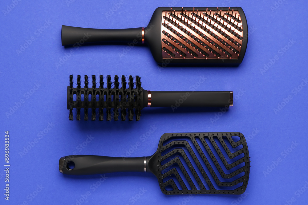 Hair brushes on blue background