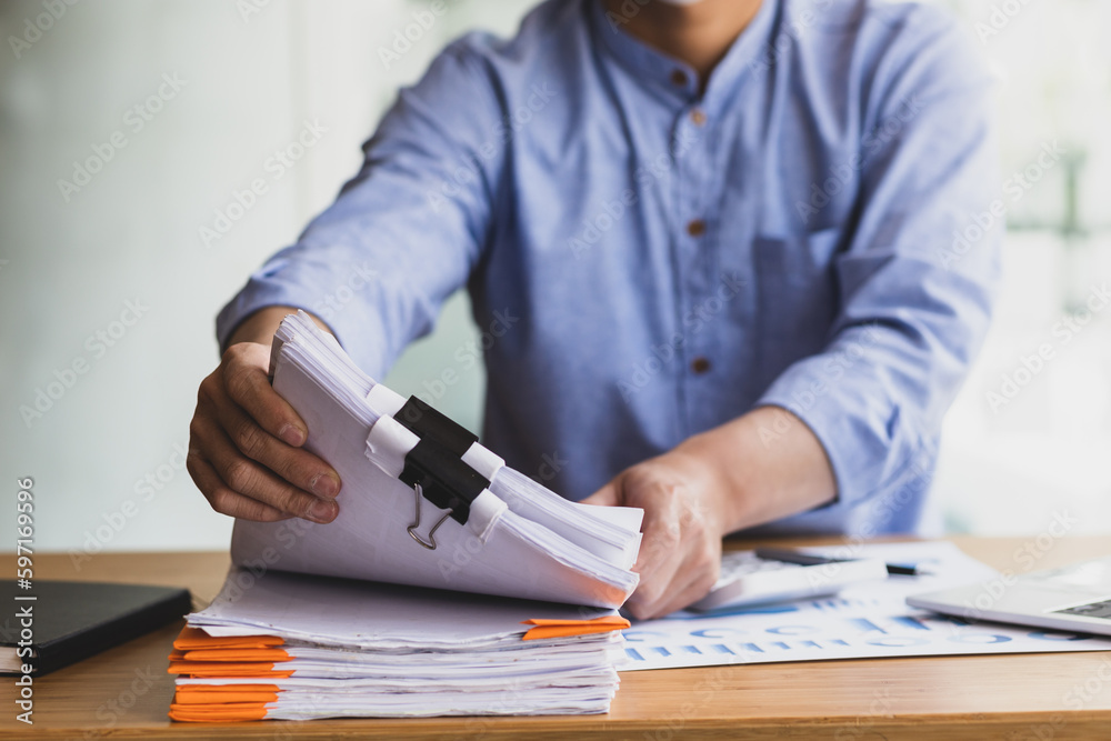 Business Documents, Auditor businessman checking working in stack of paper files for searching docum