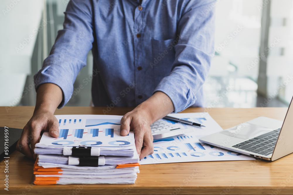 Business Documents, Auditor businessman checking working in stack of paper files for searching docum