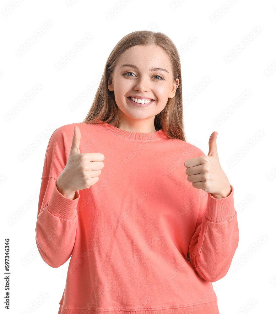 Young woman in red sweatshirt showing thumbs-up on white background