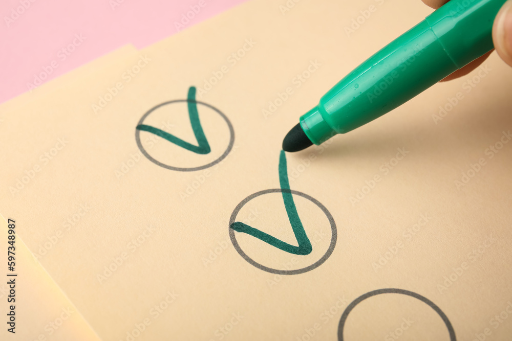 Green pen marking on checklist box, closeup