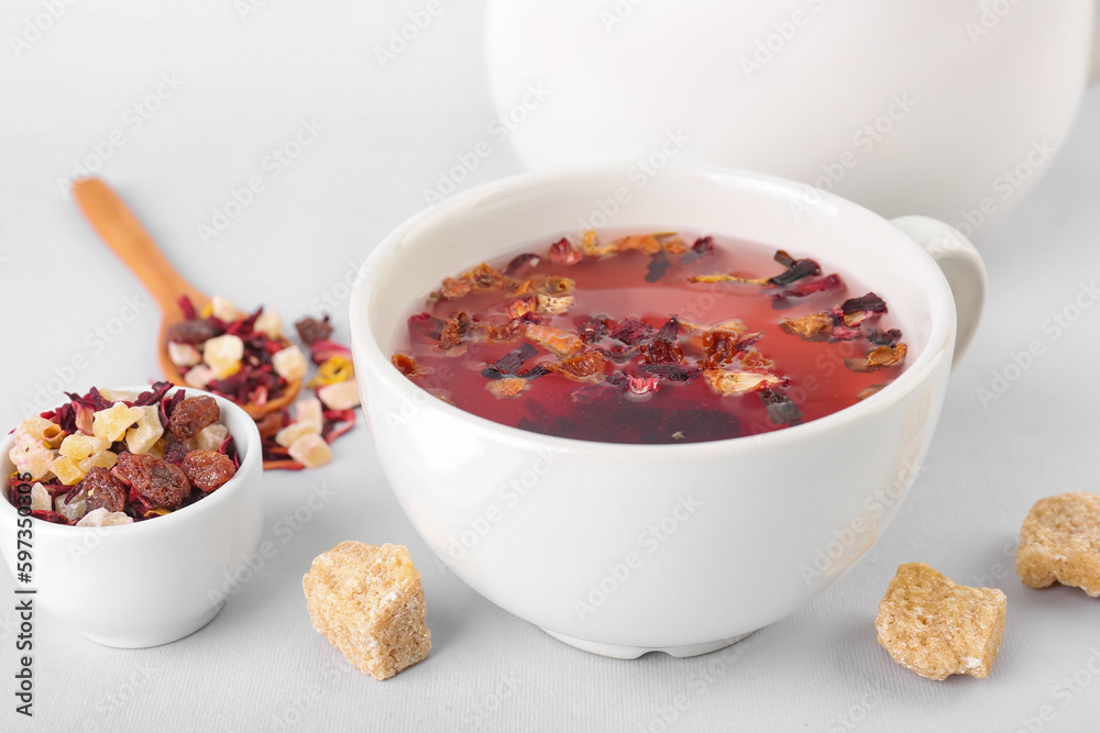 Cup of fruit tea with snacks isolated on white background