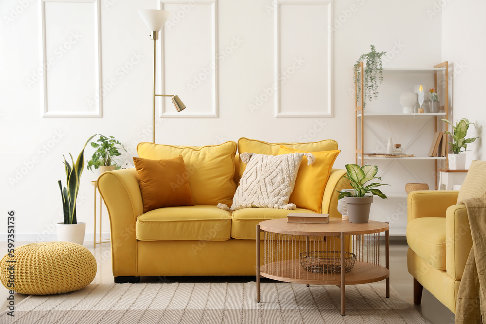 Interior of stylish living room with cozy sofa, armchair and coffee table