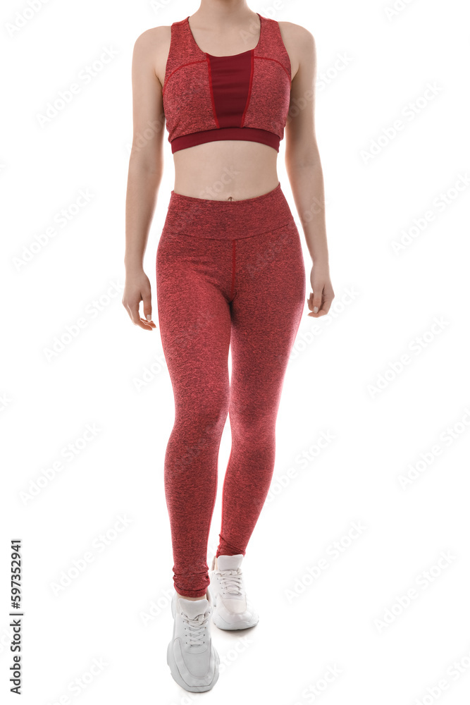 Sporty young woman in leggings on white background