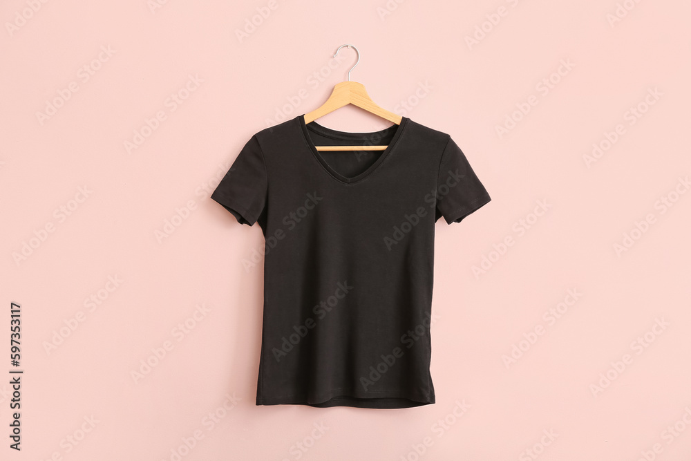 Black t-shirt hanging on pink wall