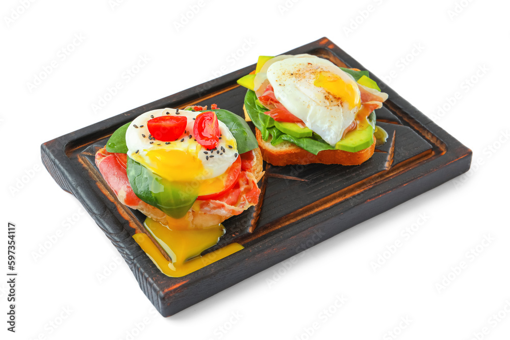 Wooden board with tasty eggs Benedict isolated on white background