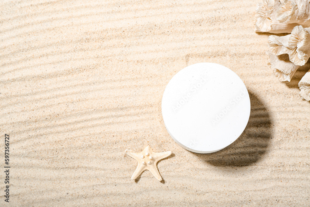 Decorative plaster podium, starfish and coral in sand