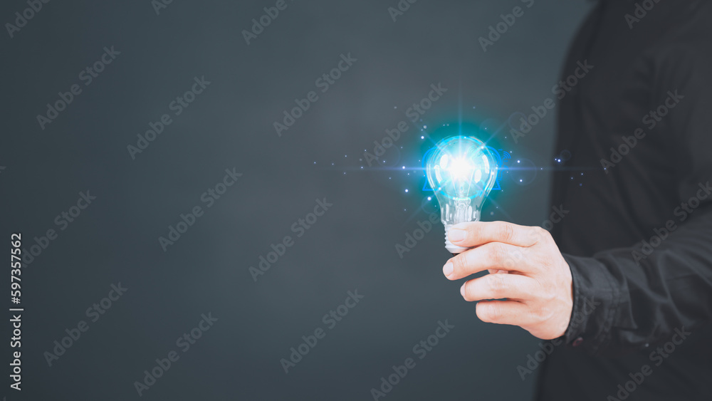 Innovation and inspiration idea. Man hand holding illuminated light bulb, creative with glowing ligh