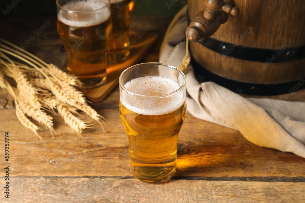 Glass of cold beer on wooden background