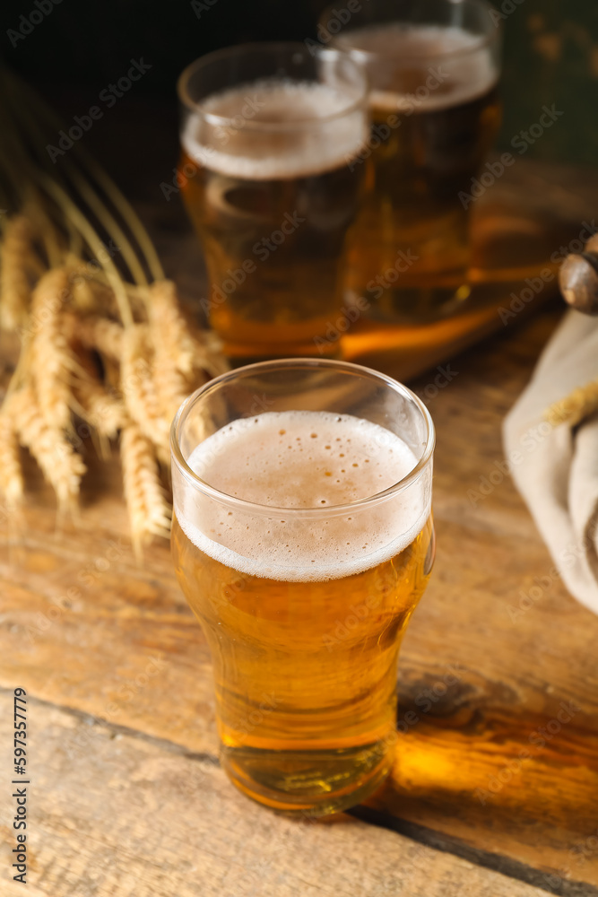 Glass of cold beer on wooden background