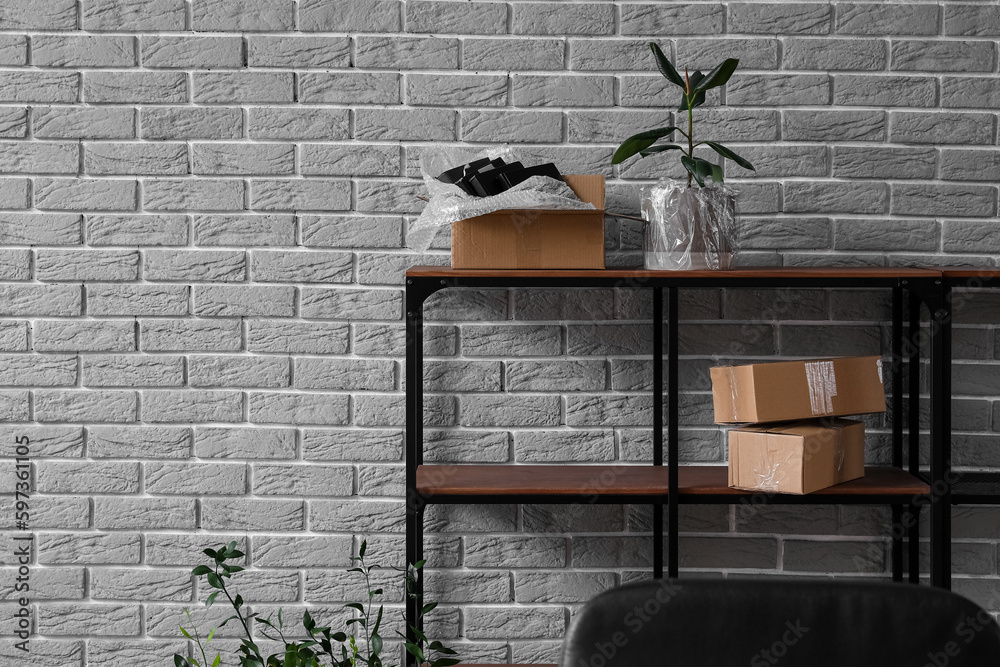 Shelving unit with cardboard boxes in office on moving day