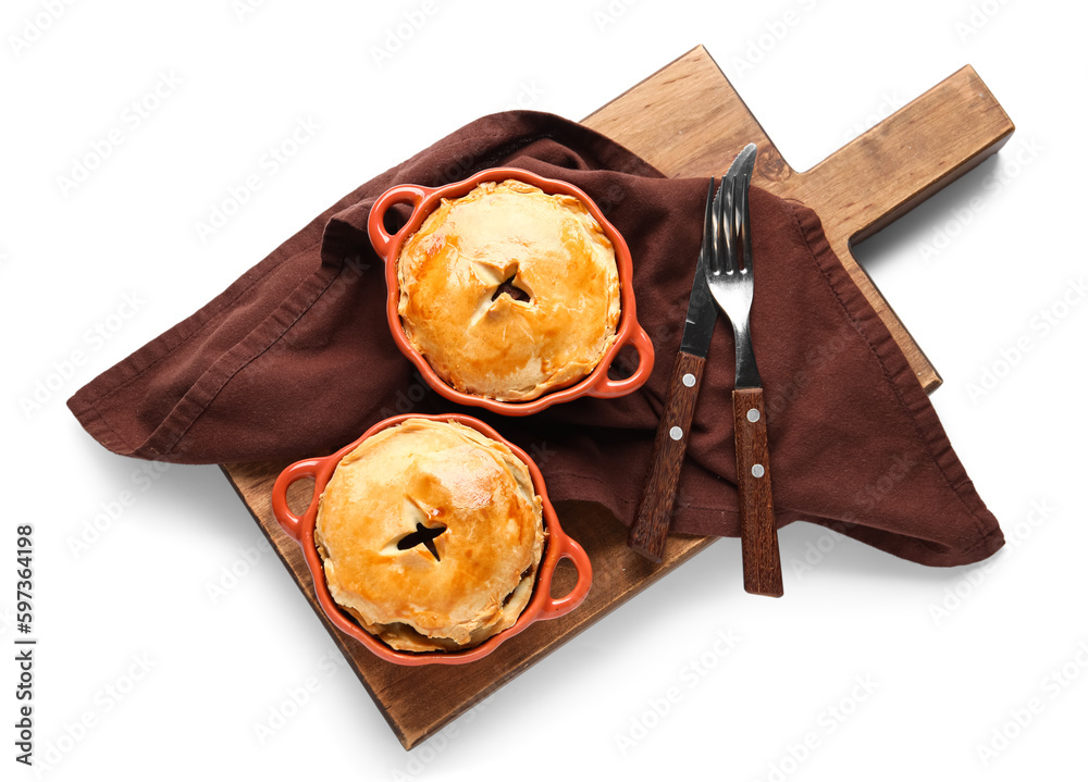 Wooden board with tasty meat pot pies on white background