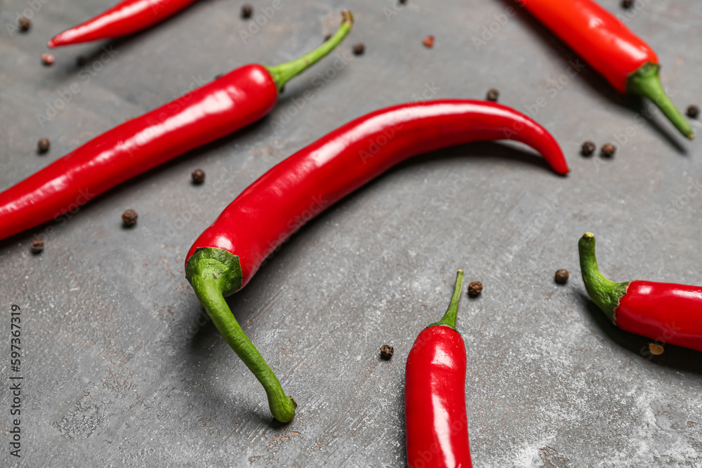 Fresh chili peppers with peppercorns on dark background, closeup