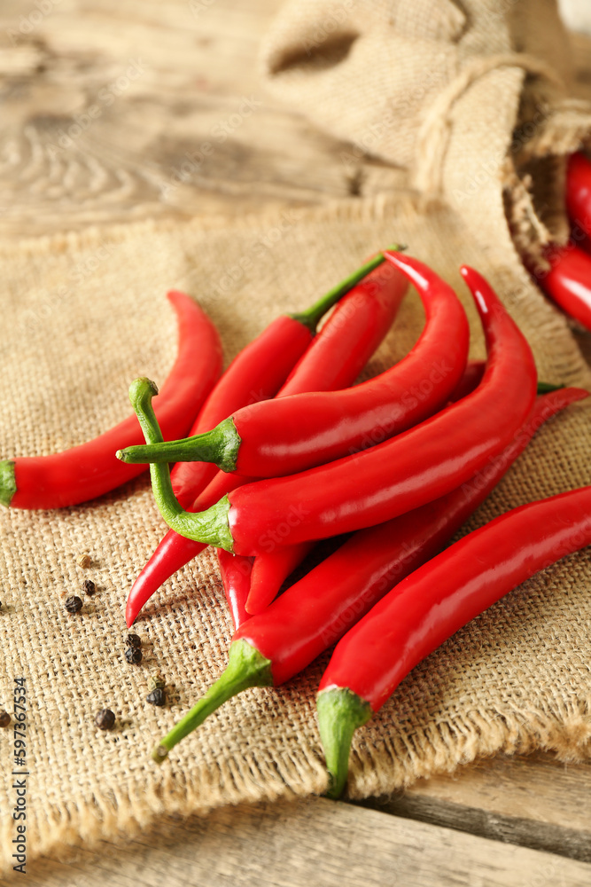 Heap of fresh chili peppers on wooden background