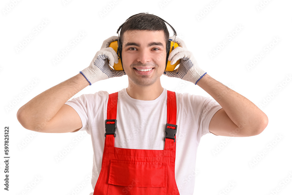 Young carpenter in hearing protectors on white background