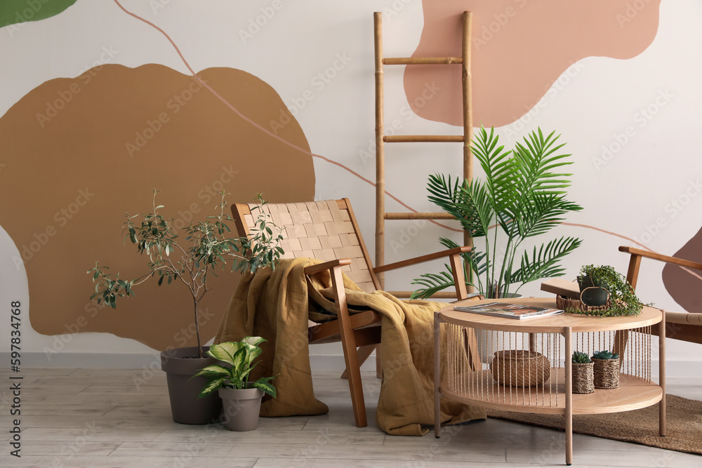 Interior of stylish living room with armchair, houseplants and coffee table